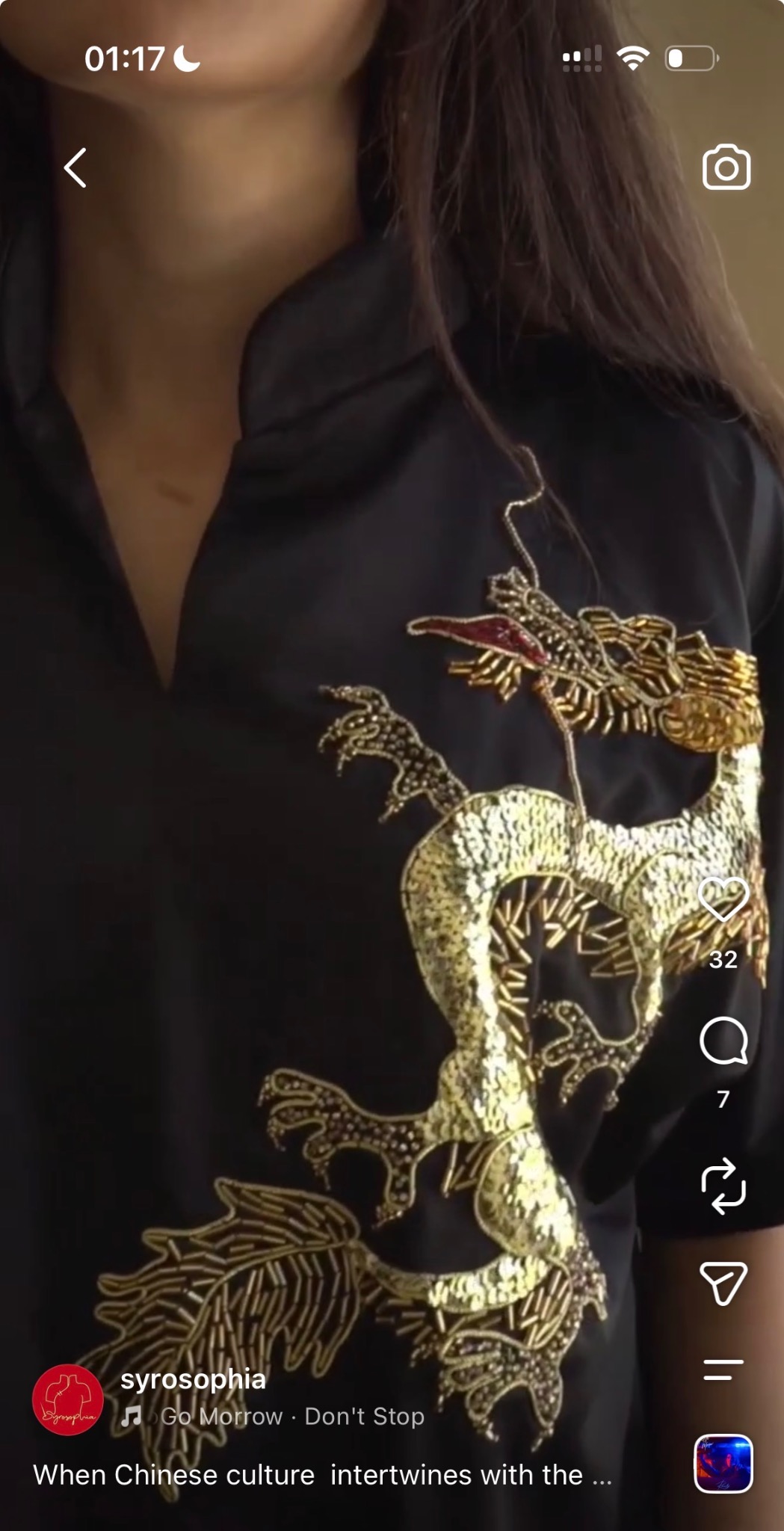 Close-up of a gold embroidered dragon on black fabric